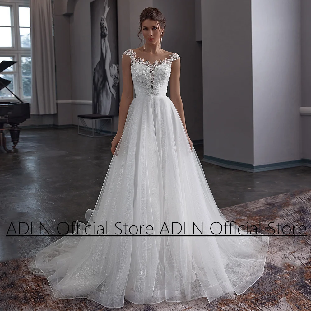 White Ivory Wedding Dress Cao Sleeve Scoop Neck Applique Illusion Back Corset with Buttons Glitter Tulle A Line Bride Gown
White Ivory Wedding Dress Cao Sleeve Scoop Neck Applique Illusion Back Corset with Buttons Glitter Tulle A Line Bride Gown