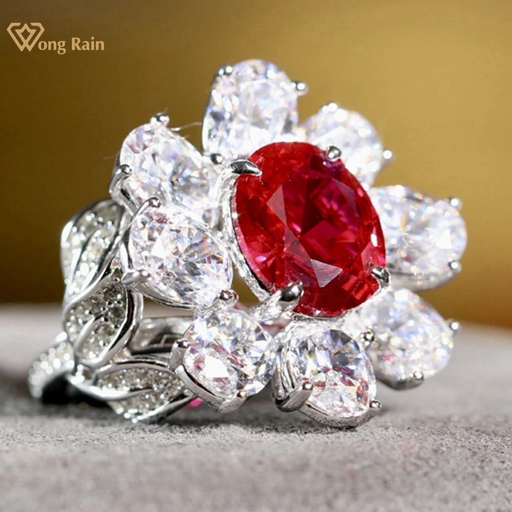 

Wong Rain Luxury 925 Sterling Silver Oval Cut Ruby High Carbon Diamond Gemstone Jewelry Cocktail Party Flower Ring for Women