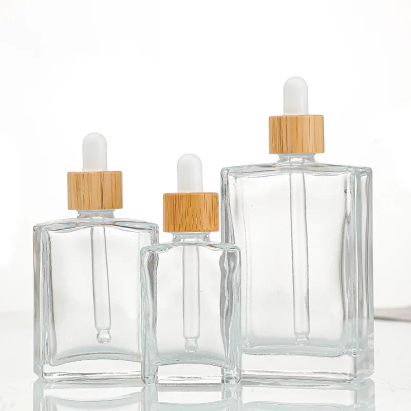 

Transparent 30ml 50ml 100ml Flat Square Cosmetic Serum Essential Oil Glass Dropper Bottle with Bamboo dropper Cap 15ml