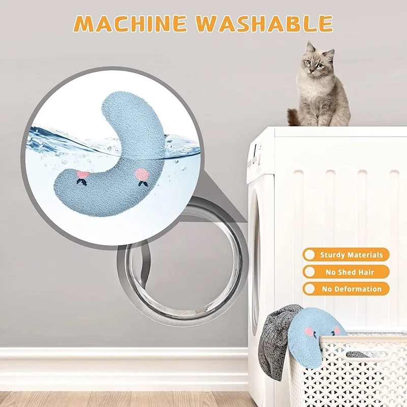 A grey cat sits on a washing machine with the lid open, observing as a Cozy Pet Pillow for Cats and Small Dogs by The Stuff Box is being machine washed. The text highlights the pillow as machine washable and sturdy, made from soft & cozy material that ensures no-shed hair and no deformation, perfect as a little pillow for cats seeking calming and anxious relief.