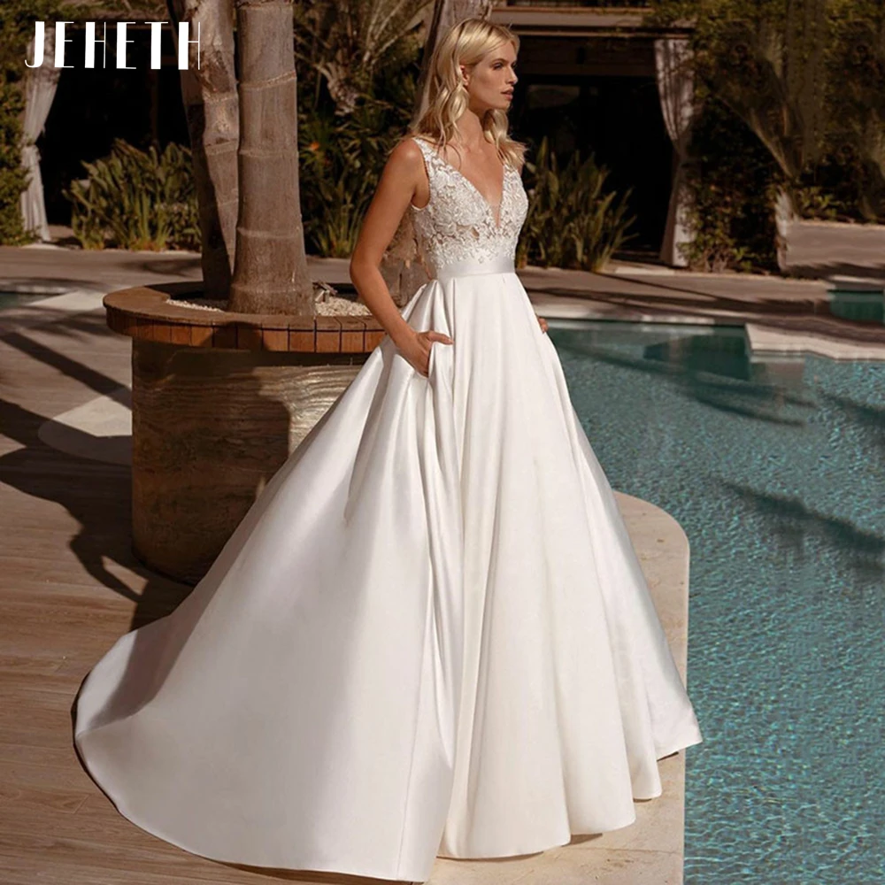 JEHETH Beach V-neck Wedding Dress Satin A-line Backless Boho Lace Appliques Empire Bride Gown Pocket Sleeveless vestido De Noiva
JEHETH Beach V-neck Wedding Dress Satin A-line Backless Boho Lace Appliques Empire Bride Gown Pocket Sleeveless vestido De Noiva
