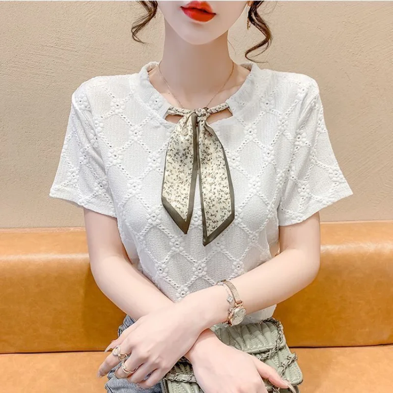 

2023 Summer Fashion Korean Edition Round Neck Lace Up Reduced Age Lace Hollow Jacquard Short Sleeve Women's Solid Color Shirt