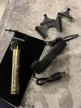 Moda Cortadora de cabello profesional cortadora de pelo para cabeza calva afeitadora de barba bigotes patillas de cabello portatil recargable para hombres con una escultura exotica.