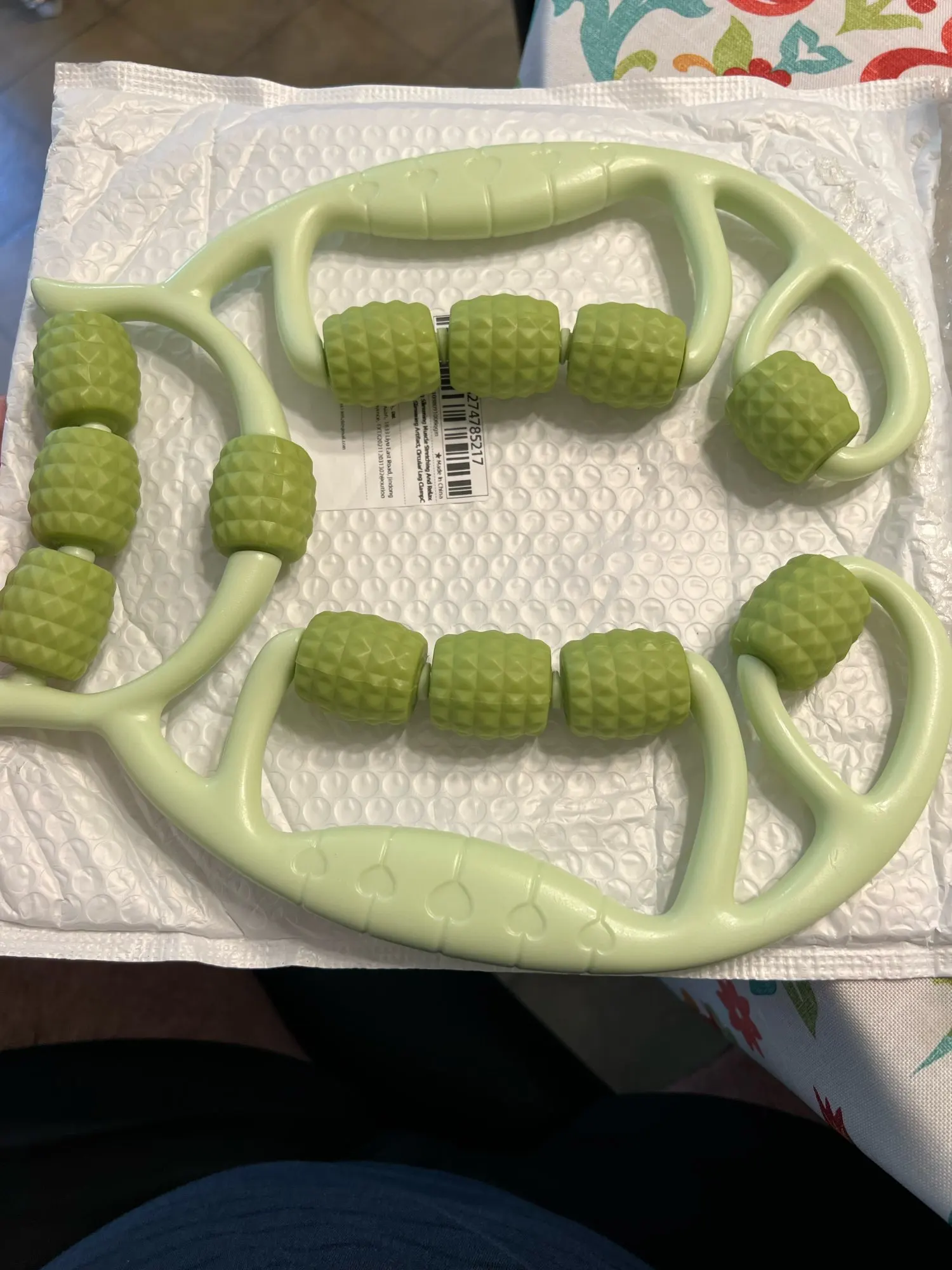 A versatile 12-wheel massage roller designed to relieve tension in legs, arms, back, shoulders, and neck. photo review