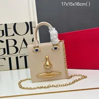 Mini sac en forme de visage pour femme, cuir noir de haute qualité, sac à main de marque de luxe, bijoux, motif œil, bandoulière en métal doré, sac bandoulière 1