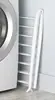 Compact white drying rack, 6"L x 26"W x 51.5"H. Freestanding and foldable for space-saving indoor use. 5