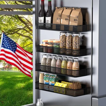 A 4-piece set of black magnetic spice racks and holders attached to the side of a refrigerator, organized with various kitchen items.