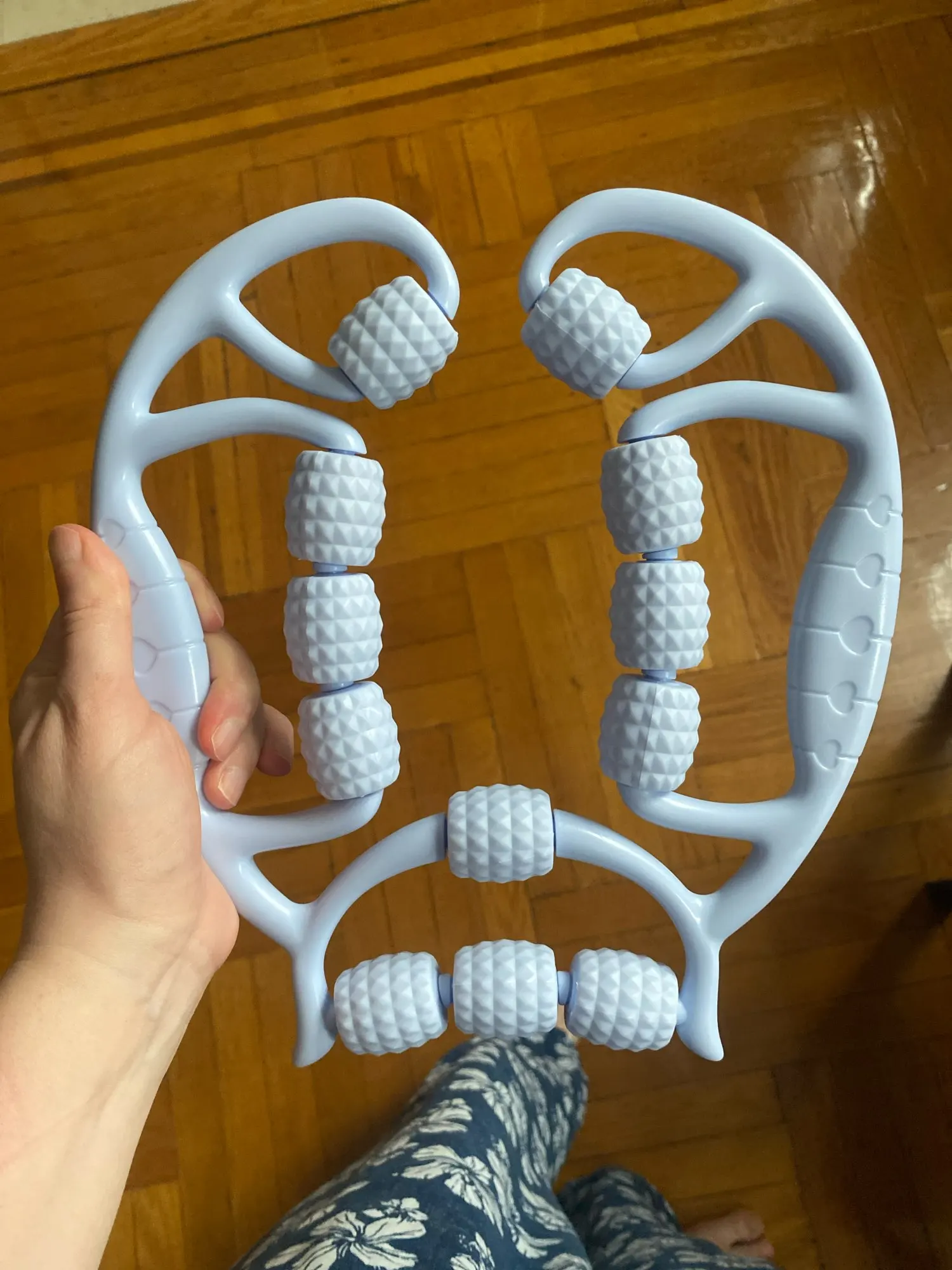 A versatile 12-wheel massage roller designed to relieve tension in legs, arms, back, shoulders, and neck. photo review