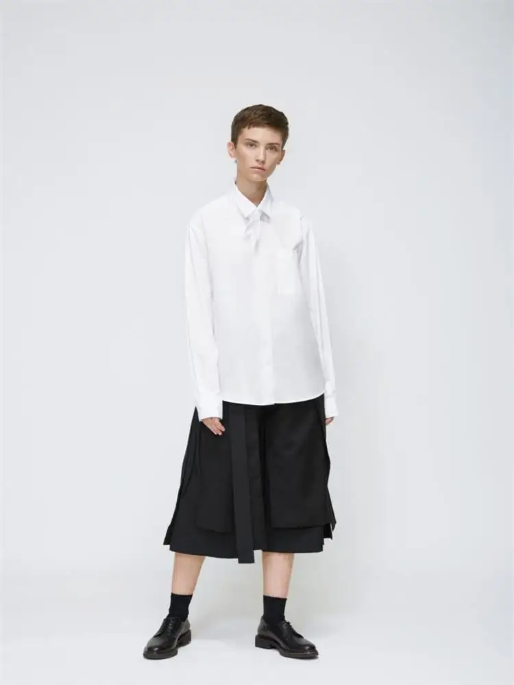 The new men\'s cropped trousers are dark and large size loose trousers with irregular asymmetrical wide legs