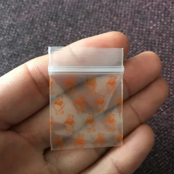 

1 pack (100 pcs)cartoon tobacco bag sealed bag Smoke storage bag Transparent orange bear pattern with holder tobacco bag 2020