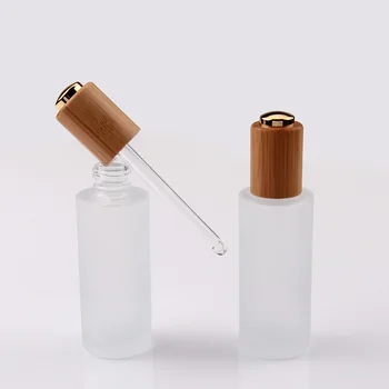 

Wooden cap flat shoulder 30ml essential oil clear frosted glass dropper bottle with bamboo wood pipette gold/silver pump lid