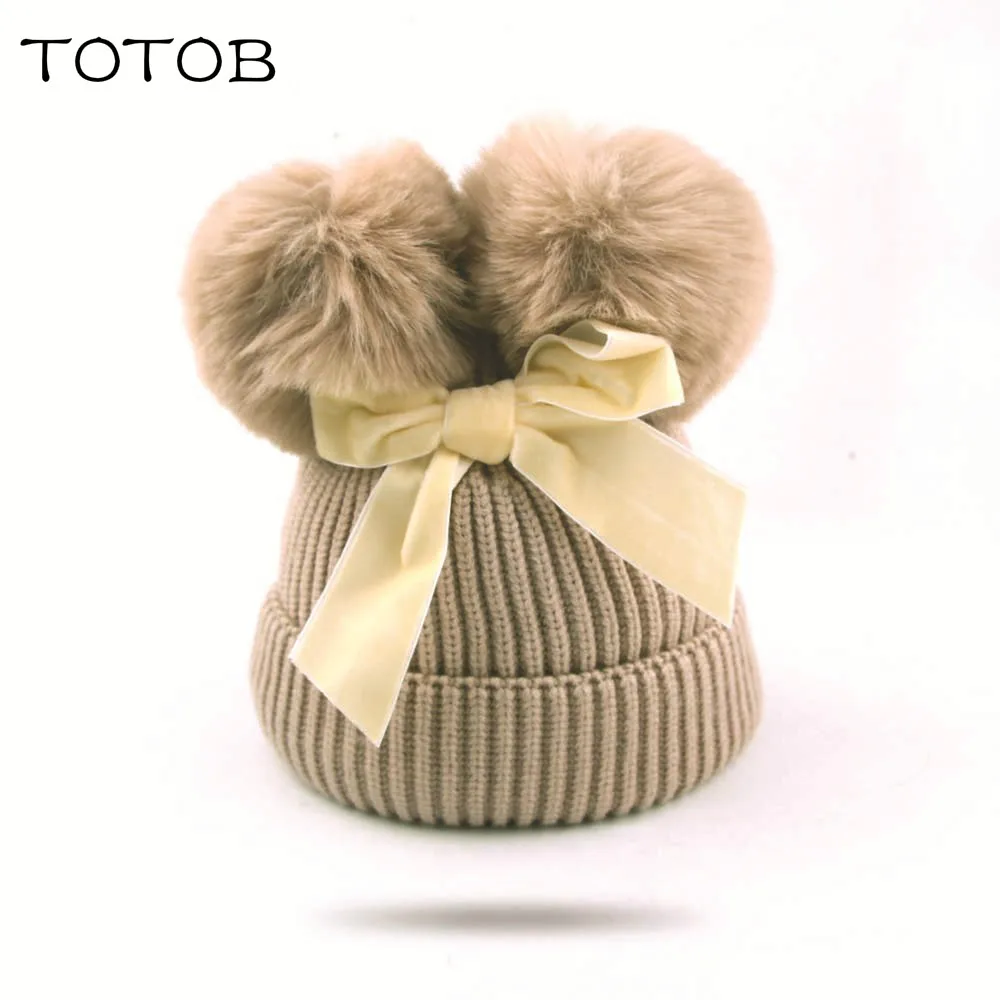 

Korean version of autumn and winter children's bow double ball knit hat girls wool hat baby thick warm warm head cap cold cap
