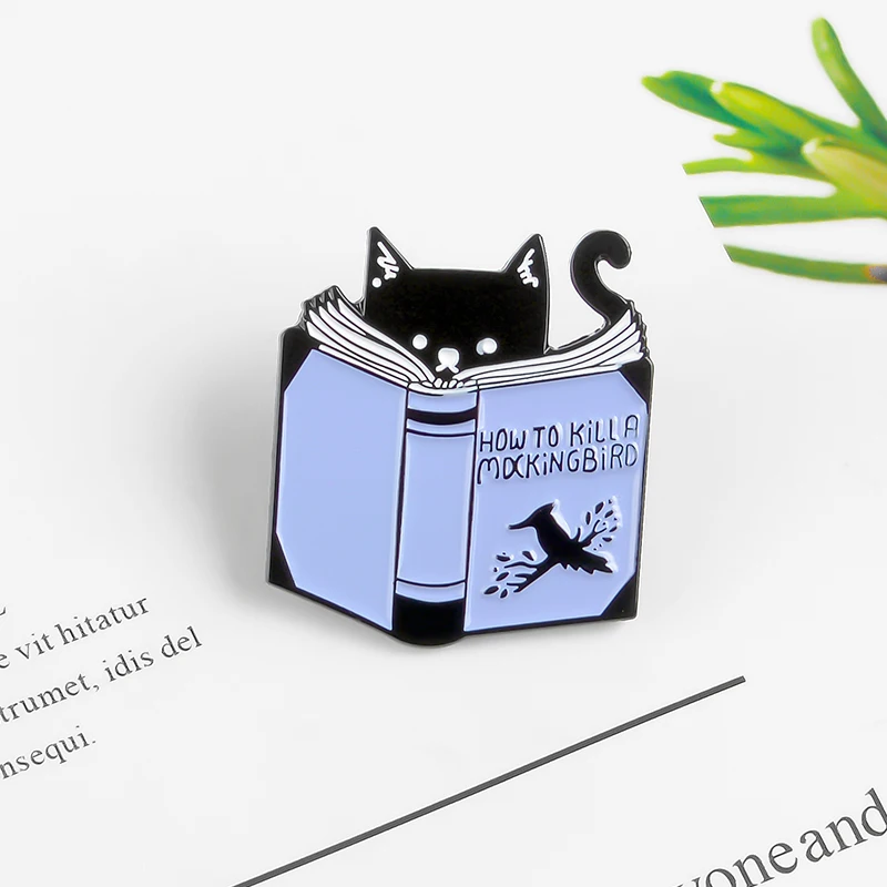 Funny black Cat looking through blue book Brooch Title 