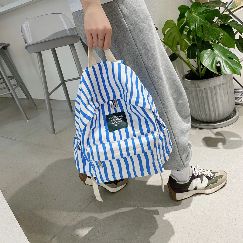 cool backpacks accessories	 Stripe Print Casual Lady Canvas Backpack New Listing Large Capacity Simple Student Backpack Fashion Wild Travel Hand Bag most stylish backpacks