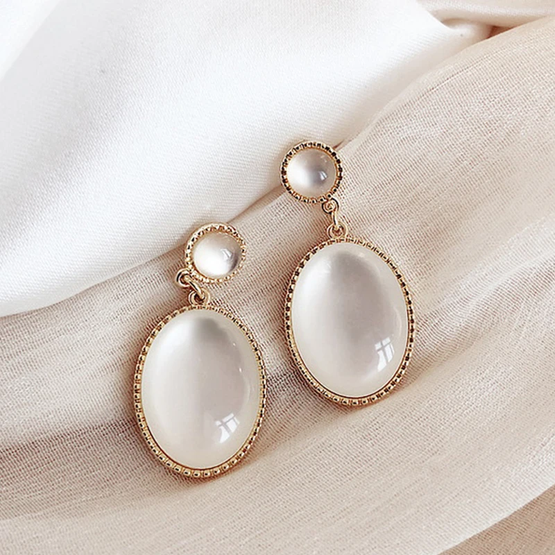 2316594-a0c5b3.jpg H0fe151c8073b4f2f87c0d1653c6cb615J Korea New White Moonlight Cat's Eye Stone Earrings For Women Small Fresh Geometric Eardrop Elegant Ladies Temperament Jewelry Mallzona
