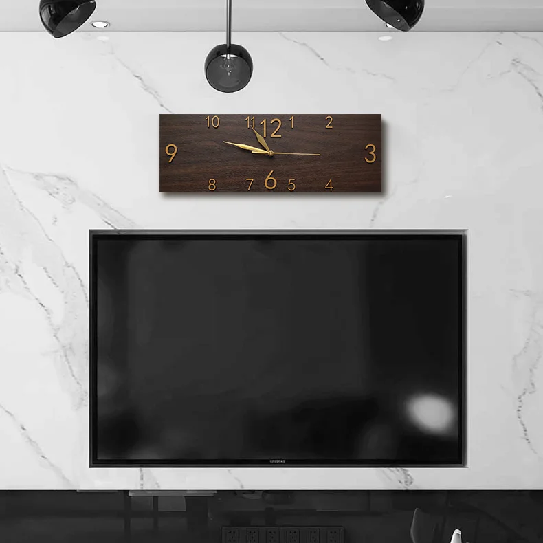 A modern rectangle wall clock above a flat-screen television in a room with a marble wall adds an elegant accessory to the space.