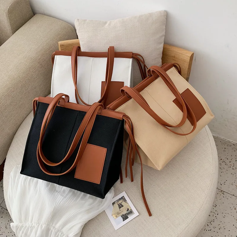 

Female bag 2019 niche new hit color generous package stitching canvas shoulder portable Messenger bag travel large capacity bag