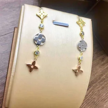 

Wholesale high quality ornaments hollow out four leaf grass earrings long style three color female Earrings
