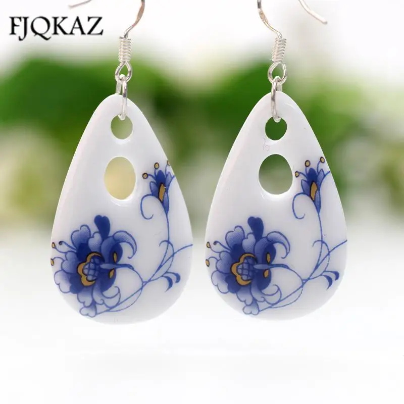 

Handmade ceramic folk style earrings women blue and white unusual gift Blue butterfly flower