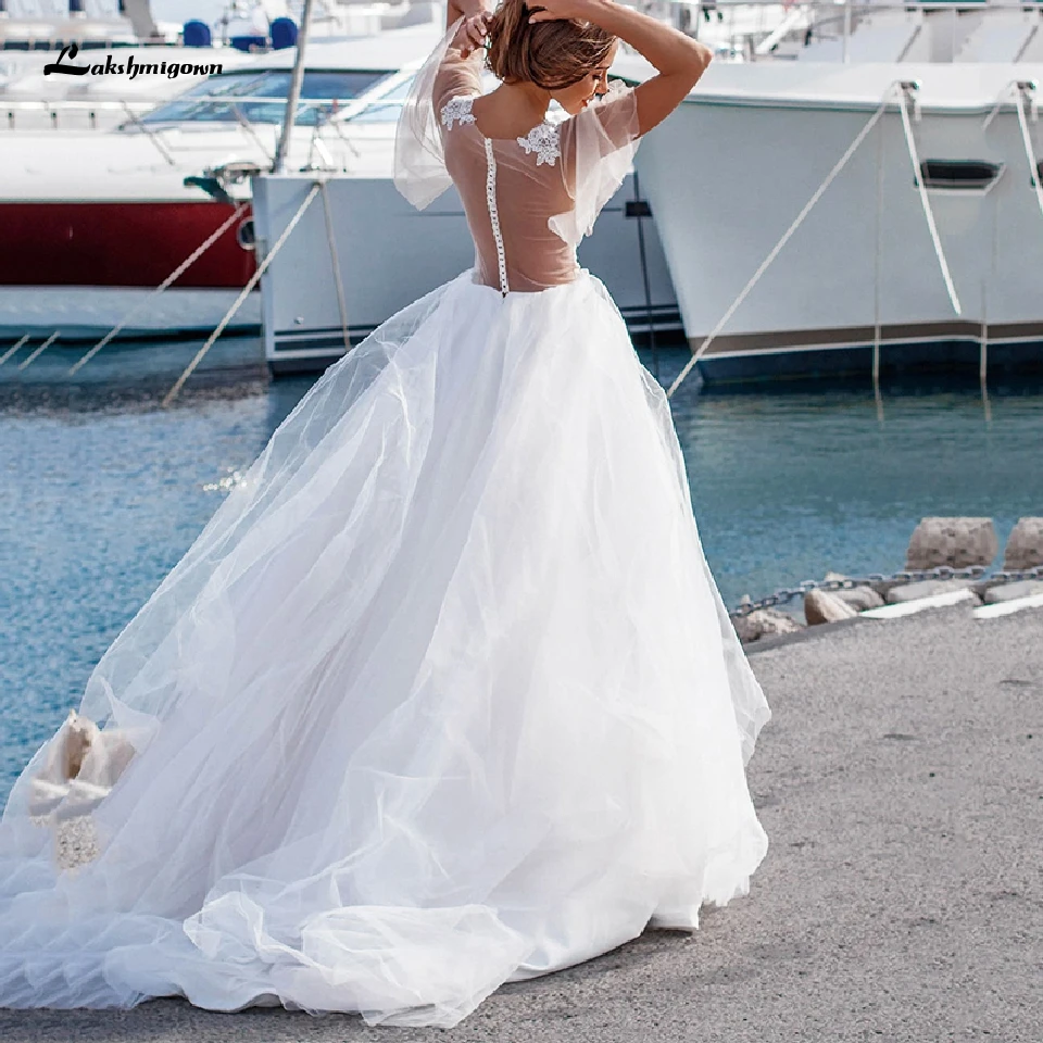

Lakshmigown Latest Princess Beach Wedding Dress 2020 White Puffy Sleeve Sheer Button Back Robe de Mariee Sexy Long Bridal Gowns