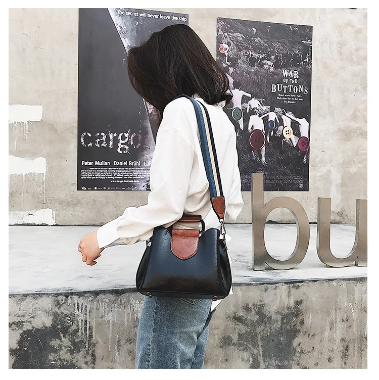 

Korean oil wax skin bucket bag simple color wide shoulder belt single shoulder oblique span handbag