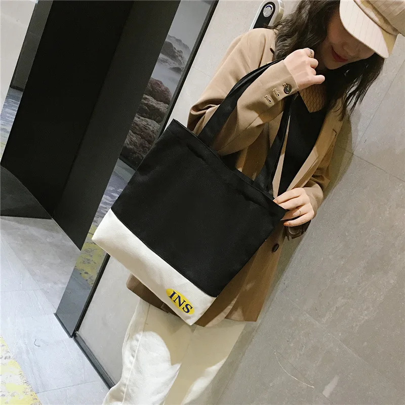 

Black And White Matching Color Canvas Large-Volume Students Handbag INS Super Fire Women's Shoulder Large Bag Simple Artistic