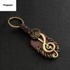 Angyape 2022 Fashion vintage brown Genuine Leather wing compass Music Symbol keychain handwork alloy Accessories men key chain ► Photo 1/6