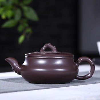 

Yixing ores are recommended by hand the teapot tea ores old plum flower purple clay evergreen pot capacity is 210 mm