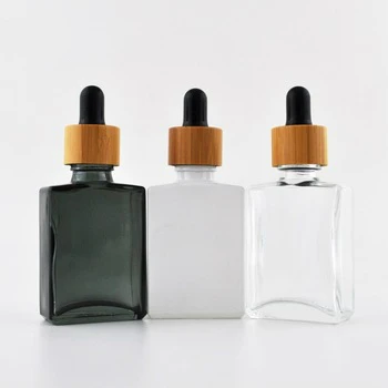 

Custom engraving logo eco friendly cosmetic skincare packaging container CBD oil glass dropper bottle 30ml with bamboo lid 1oz