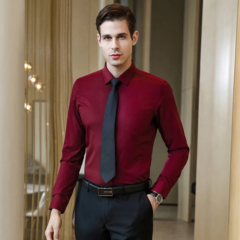 Fashion portrait of young man in green shirt and red pants poses over dark  blue wall with contrast light Stock Photo | Adobe Stock