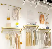 

Clothing store upper wall display rack Simple wall-mounted clothes hanger display rack for women's clothing store.