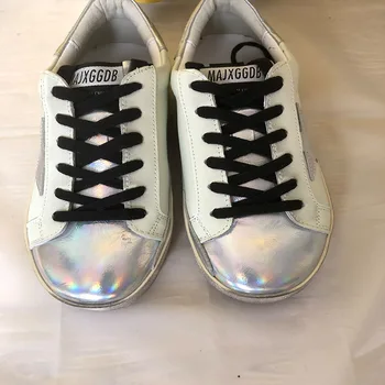 

In 2020 the new small white shoes dirty shoes spring new cowhide sneakers Laser Mirror surface collocation couples style tie-in