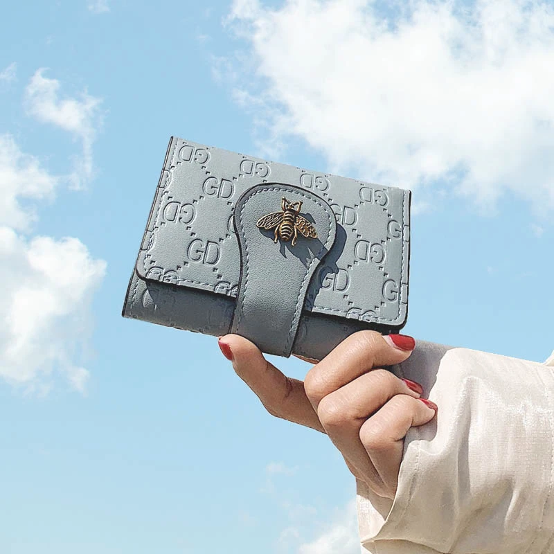 

Hot sale new female wallet Korean version of the three-fold PU leather multi-functional wild lady coin purse small bee clutch