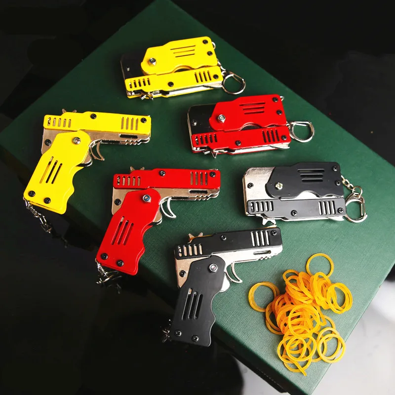 Красочный металлический мини может быть сложен как брелок пистолет с резиновой лентой детская Подарочная игрушка шесть всплесков резиновой игрушки пистолет