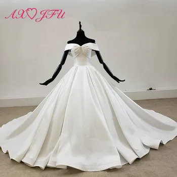 شراءAXJFU الفاخرة الأميرة العروس الكرة ثوب اليدوية الدانتيل يصل قارب الرقبة القوس الكبير الأبيض الساتان فستان الزفاف 100% صور حقيقية