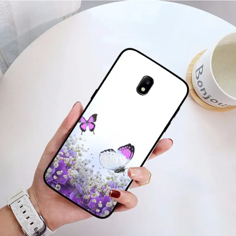 Red butterfly on white roses flower