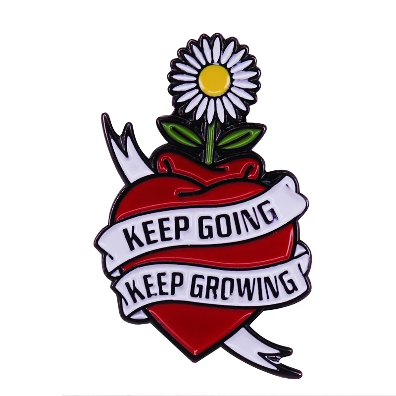 An enamel pin badge a daisy growing out of a heart Inspiring brooch full of love