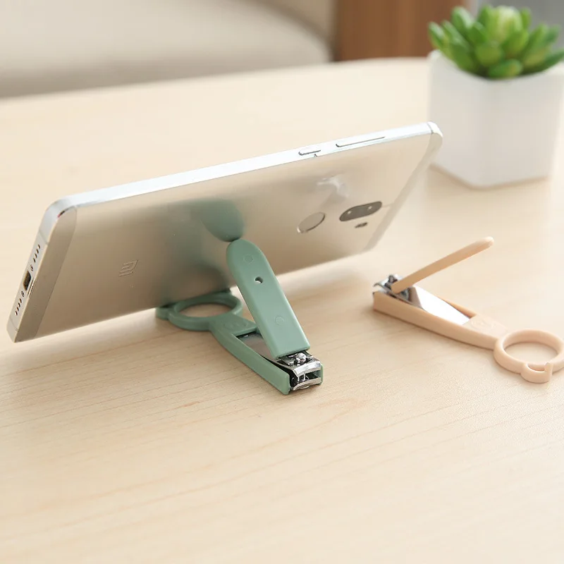 

High-quality Creative New Multifunctional Cute Nail Clipper Phone Holder Portable Nail Scissors Stable Cellphone Base