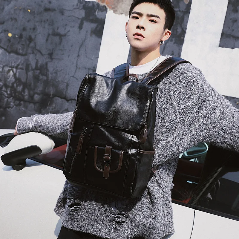 

The new leisure double shoulder bag men's backpack Korean version of the student bag leather fashion