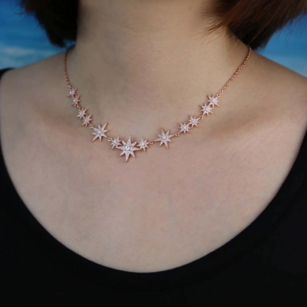 Model wearing a CZ starburst charm choker necklace with silver finish