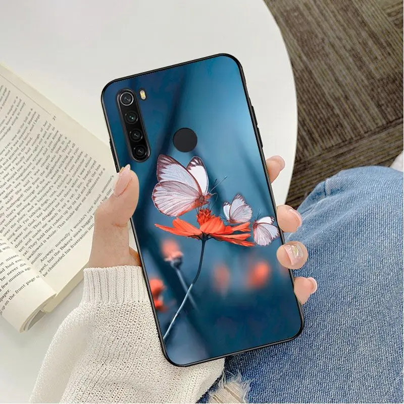 Red butterfly on white roses flower