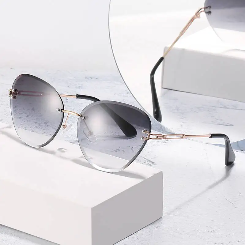 

Trendy Large Frame Frameless Sunglasses For Women 2021 Luxury Brand Retro Cat Eye Sun Glasses Female Metal Shades Eyewears