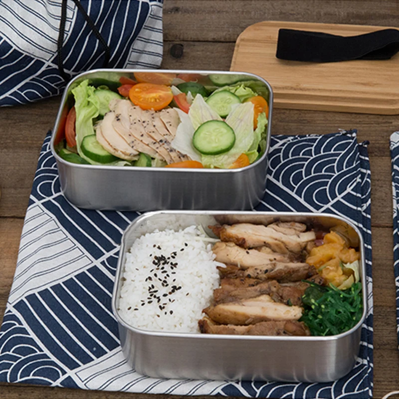 Stylish stainless steel bento box with wooden cover: perfect for lunches on the go