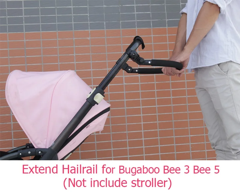 La poignée de poussée étendue de l'accoudoir d'extension remplace le  chariot de transport des poussettes de bébé