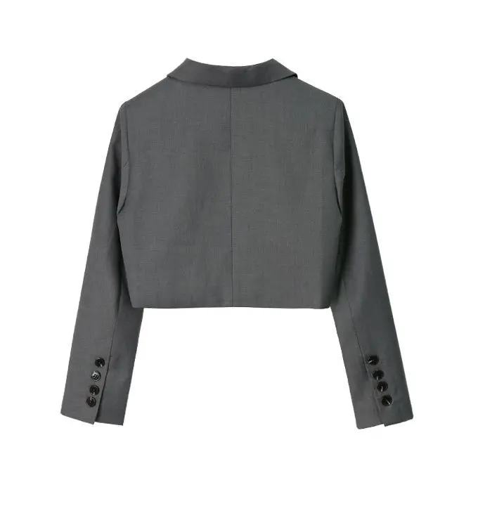 Stylish woman wearing a notched Korean-style cropped blazer in bold colors long leaves back