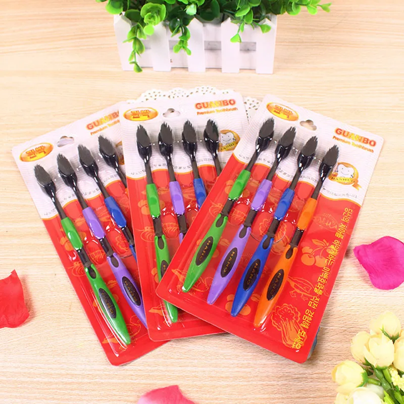 

Four black bamboo charcoal toothbrushes with sharpened, fine bristles