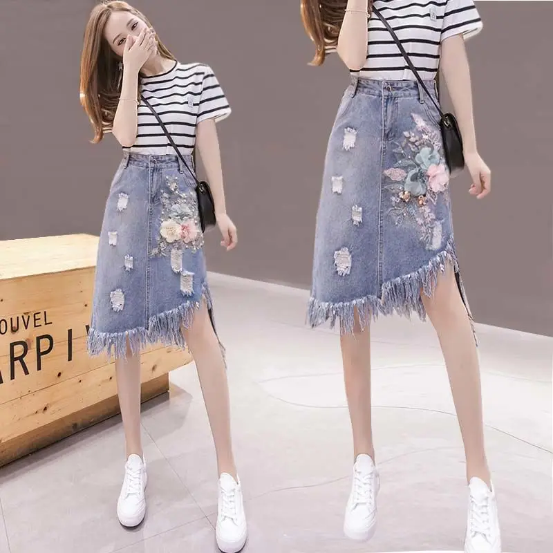 

Spring and Autumn New Korean version of high-waisted Denim hemline embroidery in the middle of the long skirt tassel hole irregu