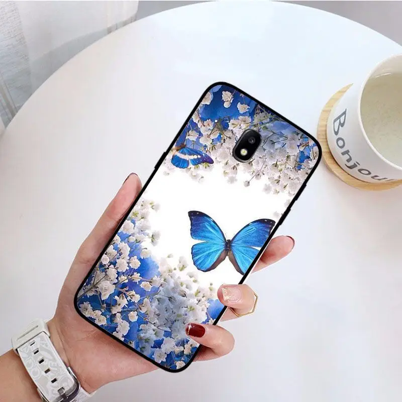 Red butterfly on white roses flower