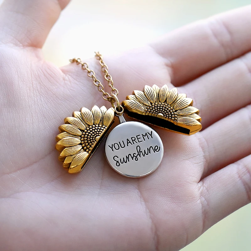 A person is holding a You Are My Sunshine Necklace.