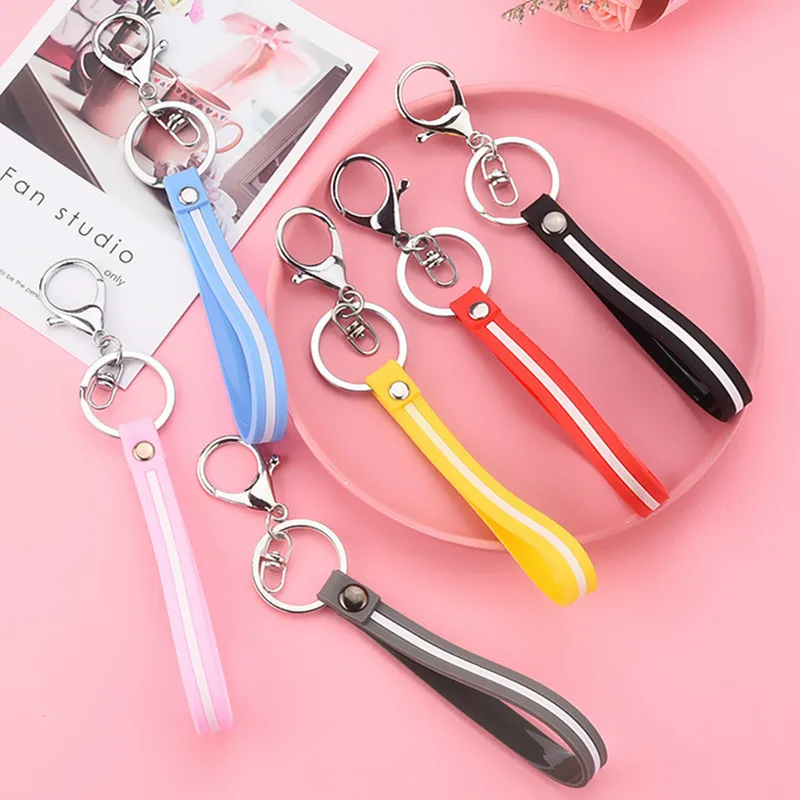 

Free Shipping Fashion Color Striped Leather Cord Keychain PVC Soft Rubber Hand Strap Pendant Cartoon Doll Car Key Lanyard